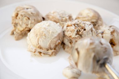 Dondurma kaşık toz beyaz yuvarlak tabak kaşık dondurma için ile yakın çekim.