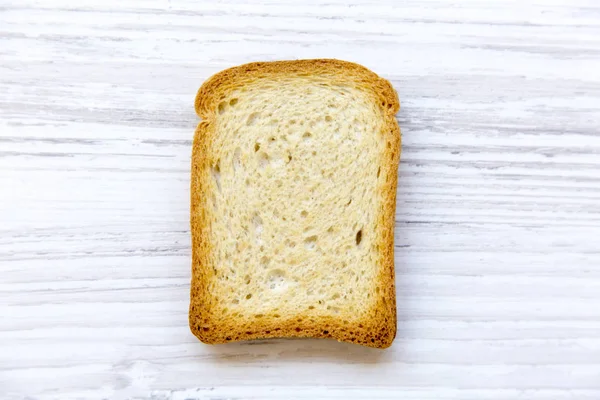 Single Toast White Wooden Background Top View — Stock Photo, Image