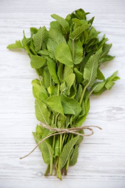 Üstten görünüm, Beyaz ahşap zemin üzerinde taze nane. Portre.