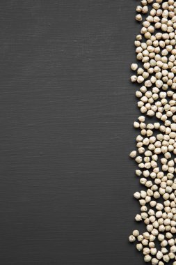 Kuru nohut bir siyah ahşap yüzeyde yukarıdan görüntüleyin. Boşluk ve metin alanı Kopyala.