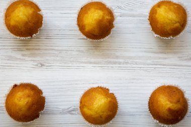 Havai görünümü taze lezzetli kek veya muffins Beyaz ahşap bir masa üzerinde. Yukarıdan görünüm üst. Portre.