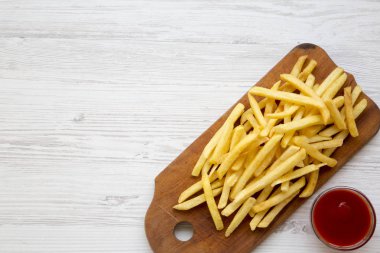 Ahşap tahta ve beyaz ahşap arka plan, havai görünümü üzerinde soslu patates kızartması. Yukarıdan, lay düz. Kopya alanı.