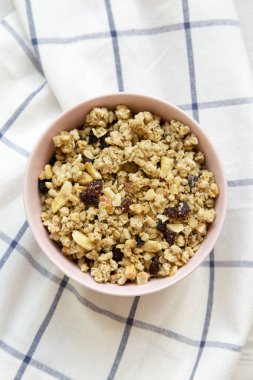 Meyve granola kumaş, havai görünümü üzerine pembe kase. Yakın çekim.