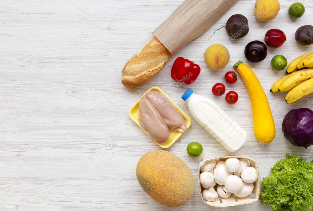 Set of various healthy food on white wooden surface, top view. Cooking food background. Healthy food concept. Space for text.