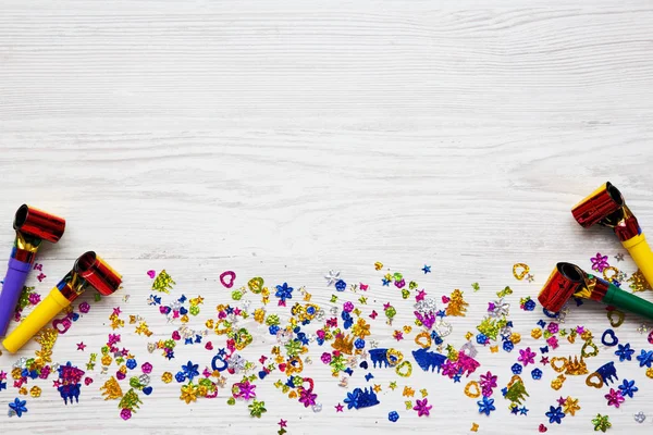 Decoration party pattern on white wooden background, overhead. Flat lay, from above, top view. Copy space.