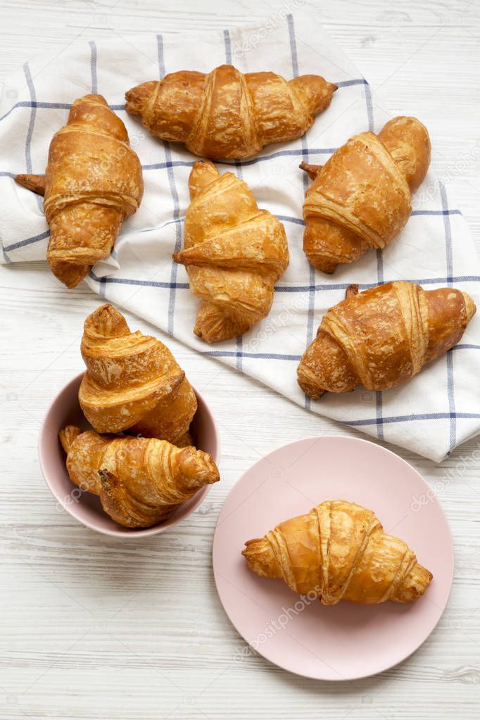 Fresh croissants with golden crust, overhead view. From above, top view.