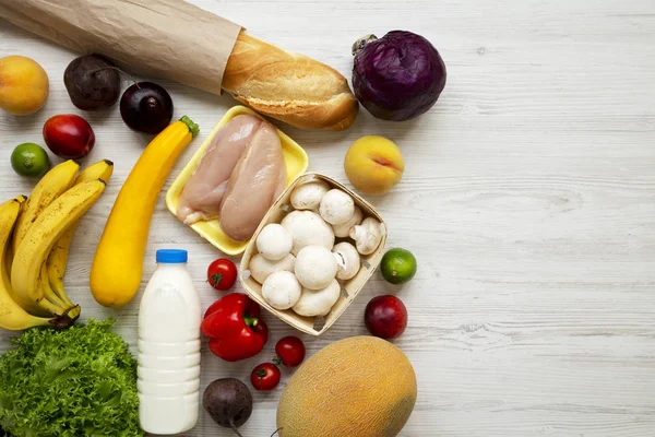 Set of various healthy food on white wooden table, top view. Cooking food background. Healthy food concept. Copy space.