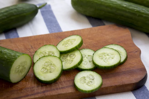 Sliced Raw Organic Green Cucumbers Rustic Wooden Board Side View — Stock Photo, Image