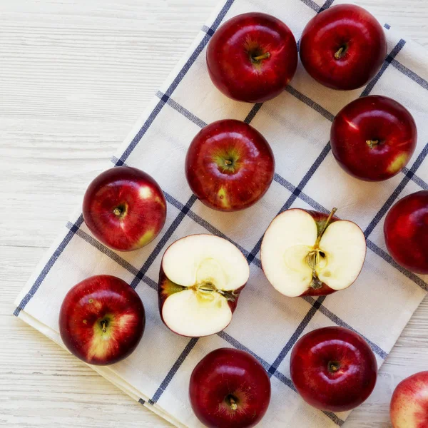 Fresh raw red apples on white wooden table, overhead view. Flat lay, top view, from above. Space for text.
