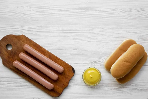 Hotdog Ingredients Sausages Wooden Board Hot Dog Buns Mustard White — Stock Photo, Image