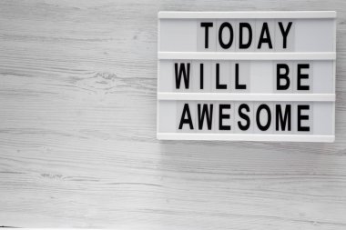 'Bugün harika olacak' kelimeleri modern beyaz ahşap zemin, havai görünümü üzerinde kurulu. Yukarıdan Lay, düz. Kopya alanı.