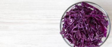 Bir kasede, havai görünümü doğranmış kırmızı lahana. Üstten görünüm, yat. Kopya alanı.