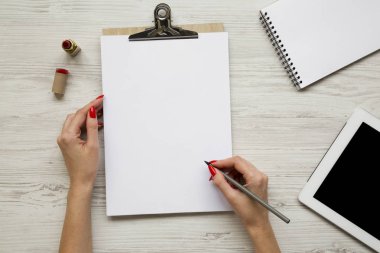 Kalem eller, ruj, tablet, Not defteri ve Pano, havai görünümü ile kadınsı çalışma alanı. Yukarıdan, üstten görünüm düz lay.