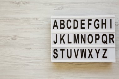 İngilizce alfabe lightbox üzerinde beyaz ahşap yüzey, en iyi görünümü üzerinde. A'dan Z'ye harfler a. Geri okul kavramı. Yukarıdan, düz, ek yükü yatıyordu. Kopya alanı.