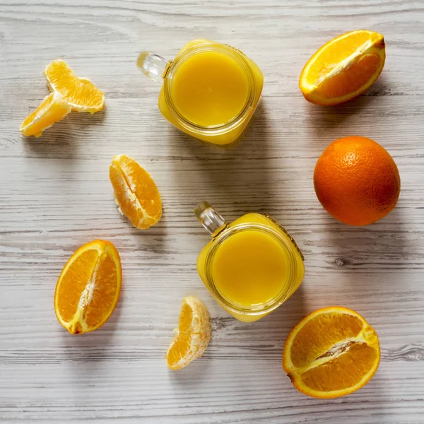 Fresh Orange Juice Glass Jars White Wooden Surface Top View — Stock Photo, Image