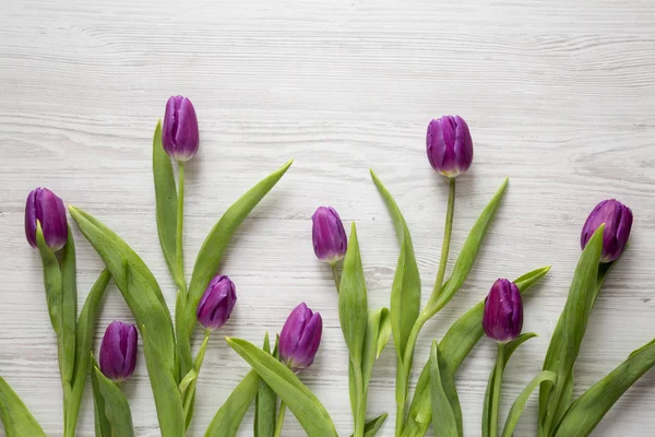 Mor laleler Beyaz ahşap arka planda, havai görünümü. Yat, yukarıdan görünüm, top. Yakın çekim.