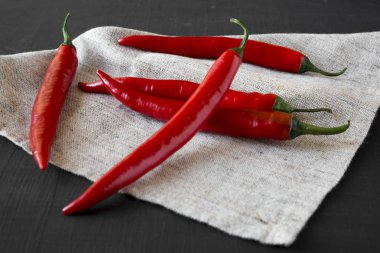 Sıcak kırmızı biber siyah yüzey, yan görünüm üzerinde. Yakın çekim.