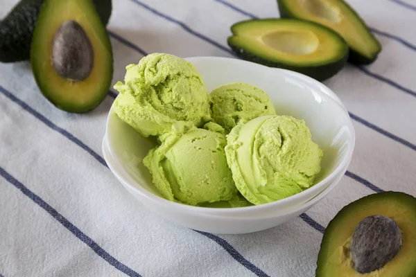 Homemade tasty avocado ice cream in a bowl, side view. Close-up.