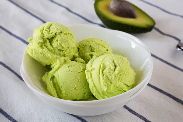 Homemade avocado ice-cream in a bowl, side view. Close-up.