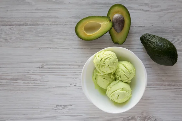 Homemade tasty avocado ice cream in a bowl, view from above. Overhead, flat lay. Copy space.
