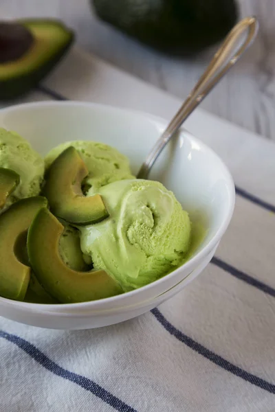 Homemade avocado ice cream in a bowl, side view. Close-up.