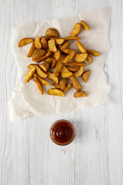 Kızarmış patates dilimleri bir beyaz tahta surfac barbekü sosu ile