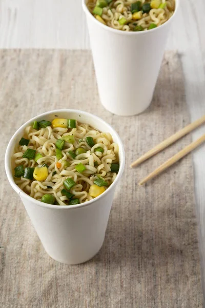 Cooked instant noodles with beef flavoring in paper cups, low an