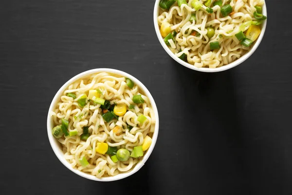 Tasty instant ramen noodles with beef flavoring in paper cups ov