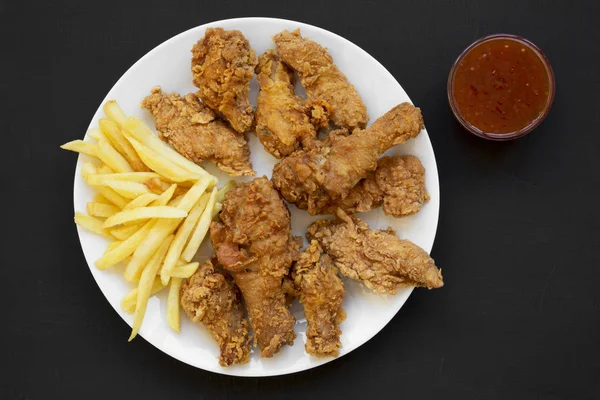 Tasty fried chicken legs, spicy wings, French fries, chicken ten