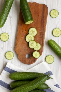 Beyaz ahşap arka plan, üstten görünüm üzerinde taze çiğ yeşil salatalık