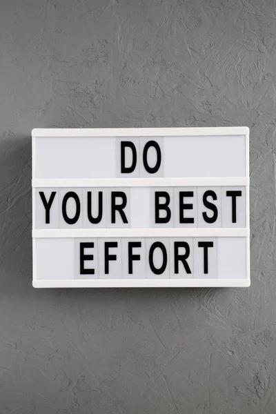 'Haz tu mejor esfuerzo' palabras en lightbox sobre fondo concreto — Foto de Stock