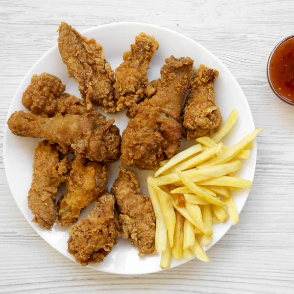 Tasty fried chicken drumsticks, spicy wings, French fries, chick