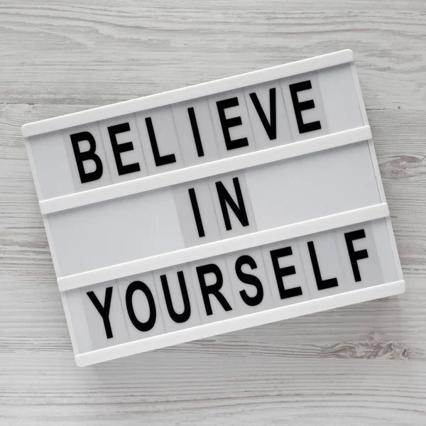 'Believe in yourself' words on modern board on a white wooden su — Stock Photo, Image