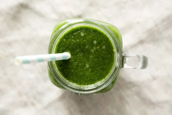 Green smoothie with spinach, avocado and banana in a glass jar, — Stock Photo, Image