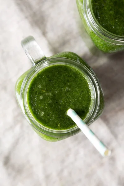 Pots en verre remplis de smoothie vert aux épinards, avocat et bana — Photo