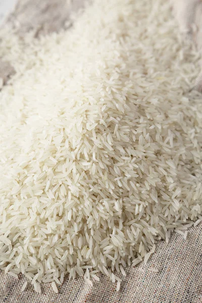 Dry white rice basmati on cloth, side view. Close-up. — Stock Photo, Image