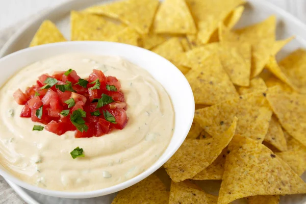 Bir kase, sarı tortilla cips, yan görünüm ev yapımı peynirli daldırma.