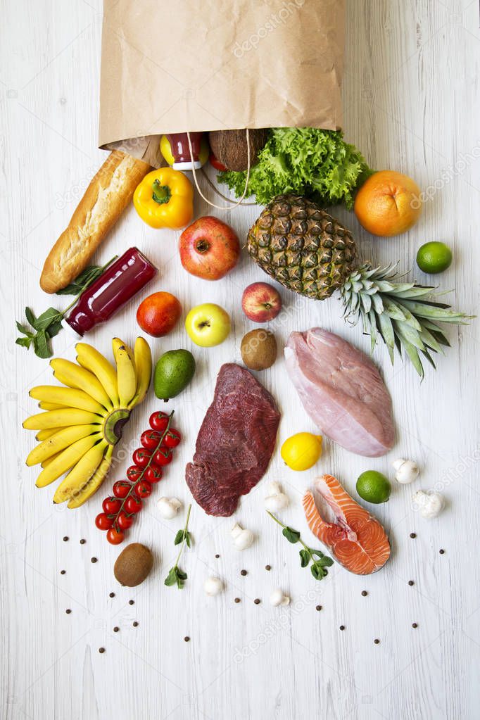 Overhead view, paper bag of different fruits and vegetables on a