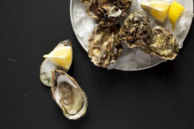 Siyah bir masada taze istiridye, üst tespüled. Yukarıdan, yukarıdan, 