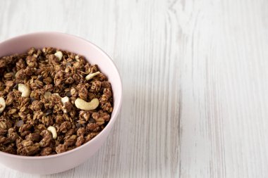 Pembe bir kase fındık ile ev yapımı çikolata granola, düşük açı v