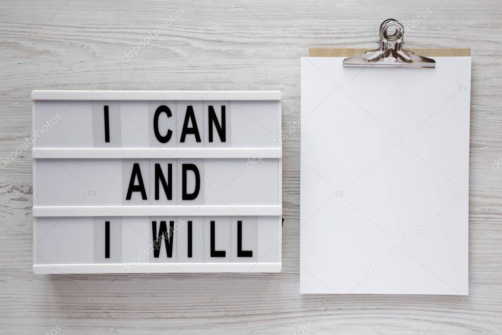 Modern board with 'I can and I will' words, clipboard with blank