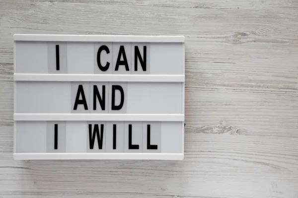 Modern board with 'I can and I will' words on a white wooden bac — Stock Photo, Image