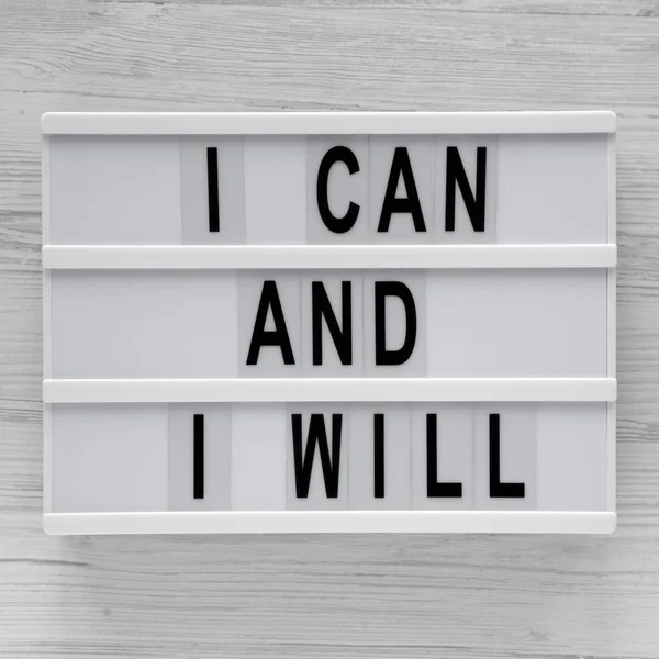 Modern board with 'I can and I will' words on a white wooden bac — Stock Photo, Image