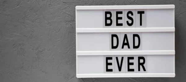 Lightbox with 'Best dad ever' words over gray surface, top view. — Stock Photo, Image