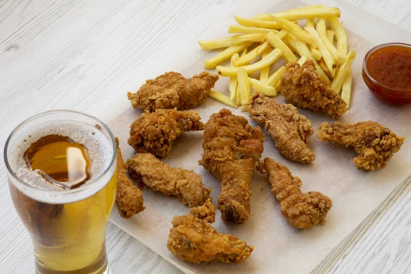 Fast food: fried chicken legs, spicy wings, French fries and chi