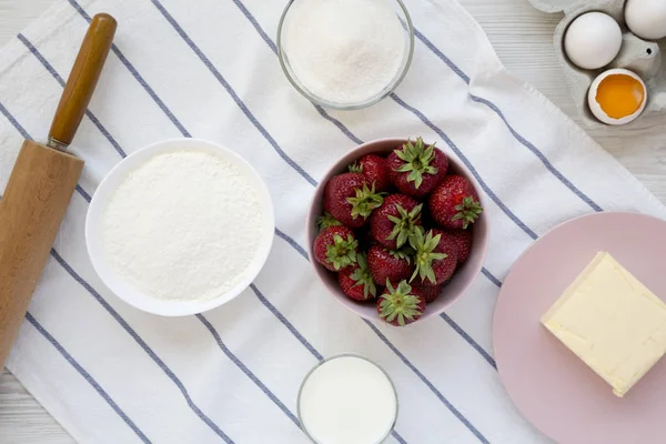 Strawberry pie ingredients (flour, eggs, butter, milk, sugar, st
