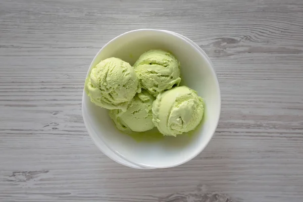Homemade avocado ice cream in a bowl, top view. Overhead, flat l