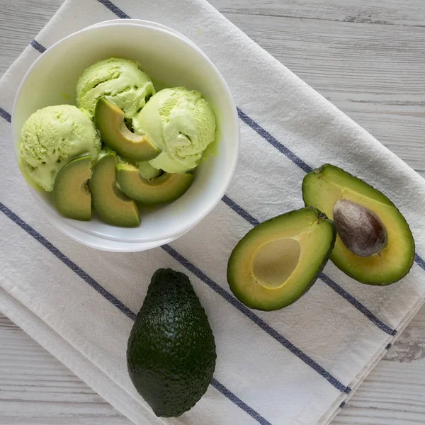 Homemade avocado ice cream in a bowl, top view. Overhead, flat l