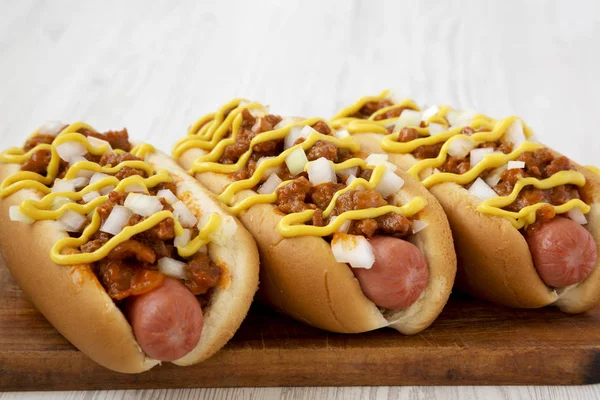 Homemade Coney Island hot dog on a rustic wooden board on a whit — Stock Photo, Image