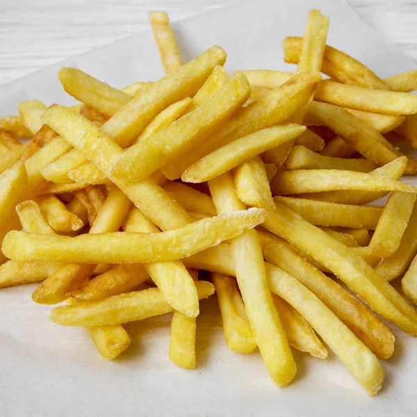 Tasty french fries, close-up. Side view.